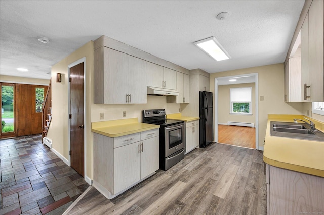 24 Iron Gate Ln, Cromwell, CT 06416 - kitchen featuring stainless steel electric range, under cabinet range hood, a baseboard heating unit, plenty of natural light, and a textured ceiling