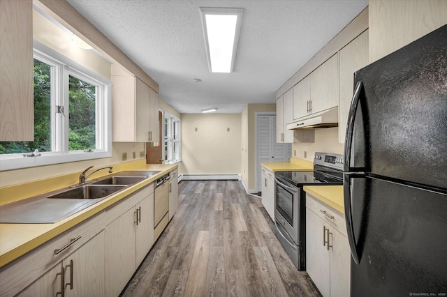24 Iron Gate Ln, Cromwell, CT 06416 - kitchen featuring appliances with stainless steel finishes, under cabinet range hood, a baseboard heating unit, wood finished floors, and light countertops