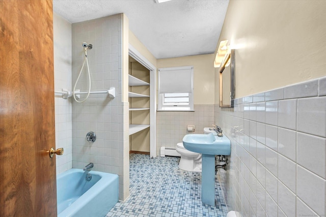 24 Iron Gate Ln, Cromwell, CT 06416 - bathroom with a baseboard heating unit, bathtub / shower combination, a textured ceiling, a wainscoted wall, and tile walls