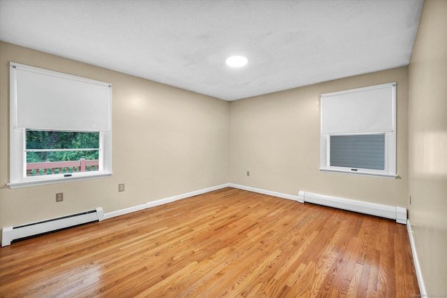 24 Iron Gate Ln, Cromwell, CT 06416 - spare room with a baseboard heating unit, a baseboard radiator, and wood finished floors
