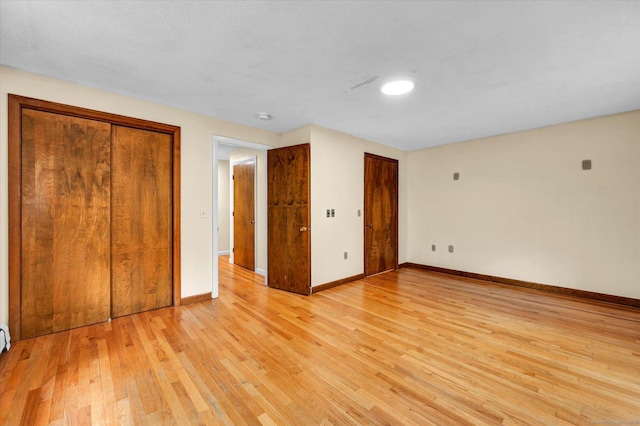 24 Iron Gate Ln, Cromwell, CT 06416 - unfurnished bedroom featuring light wood-style flooring and multiple closets