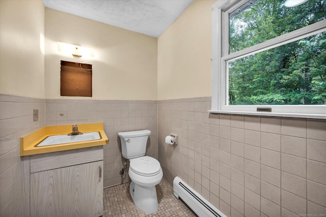 24 Iron Gate Ln, Cromwell, CT 06416 - bathroom with healthy amount of natural light, vanity, tile patterned floors, tile walls, and a wainscoted wall