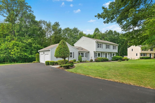33 Shawnee Ln, Monroe, CT 06468 - view of front of property with a front yard, view of wooded area, and a garage