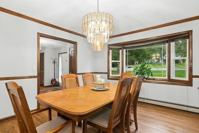 33 Shawnee Ln, Monroe, CT 06468 - dining space featuring plenty of natural light, a chandelier, baseboard heating, light wood-style floors, and ornamental molding