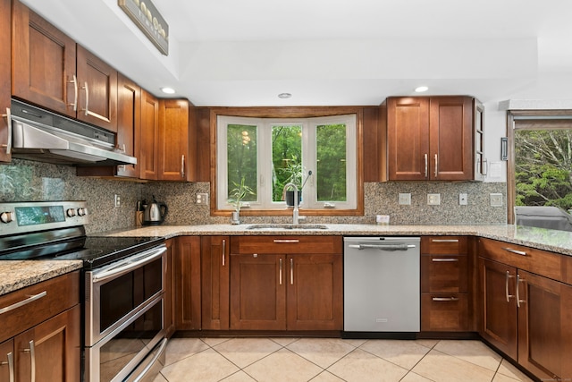 33 Shawnee Ln, Monroe, CT 06468 - kitchen with stainless steel appliances, under cabinet range hood, light stone counters, decorative backsplash, and recessed lighting