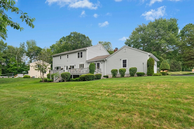 33 Shawnee Ln, Monroe, CT 06468 - rear view of house with a lawn, a wooden deck, and a chimney