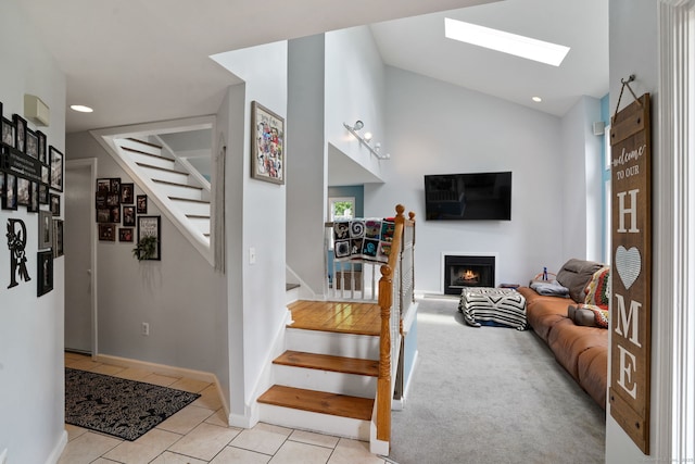 5 Legion Rd, Seymour, CT 06483 - staircase with a warm lit fireplace, tile patterned flooring, a skylight, lofted ceiling, and recessed lighting