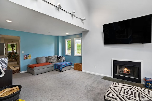 5 Legion Rd, Seymour, CT 06483 - carpeted living room featuring plenty of natural light, a fireplace with flush hearth, and recessed lighting