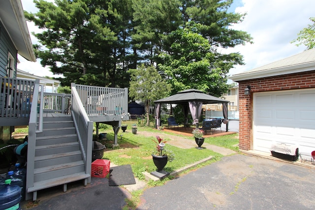 180 Victoria Rd, Hartford, CT 06114 - view of grassy yard with a gazebo, a deck, stairway, a garage, and driveway