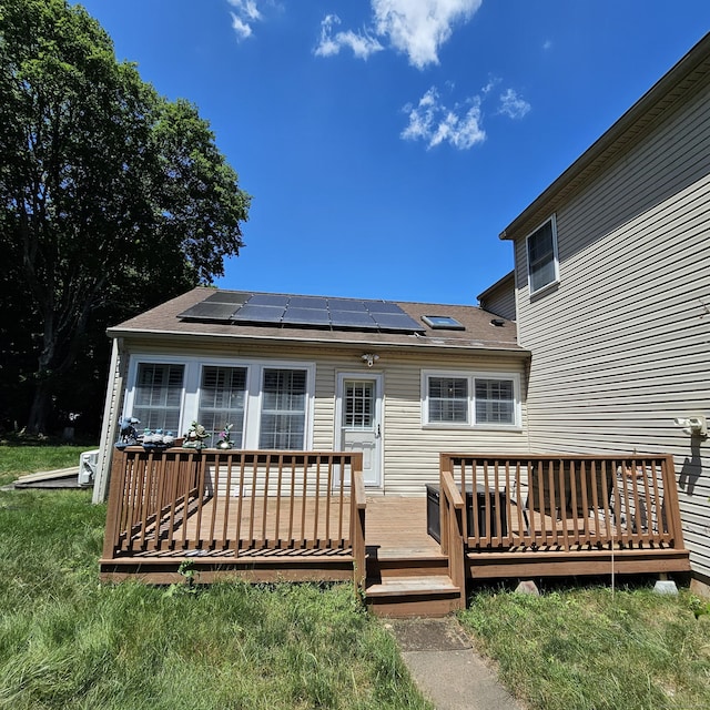 50 Meadow St, Meriden, CT 06451 - rear view of property with solar panels, a wooden deck, and roof with shingles