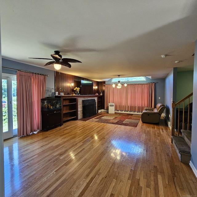 50 Meadow St, Meriden, CT 06451 - unfurnished living room with a brick fireplace, wood-type flooring, ceiling fan, and stairway