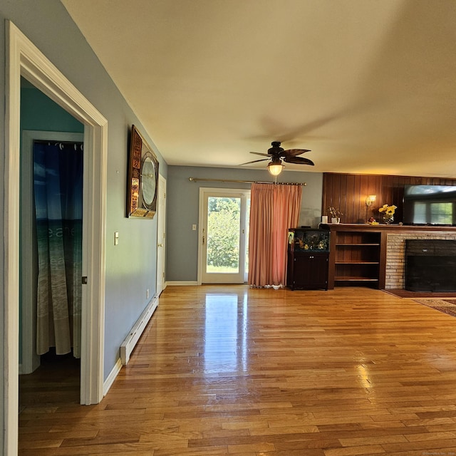 50 Meadow St, Meriden, CT 06451 - unfurnished living room featuring a baseboard heating unit, wood finished floors, ceiling fan, and a brick fireplace