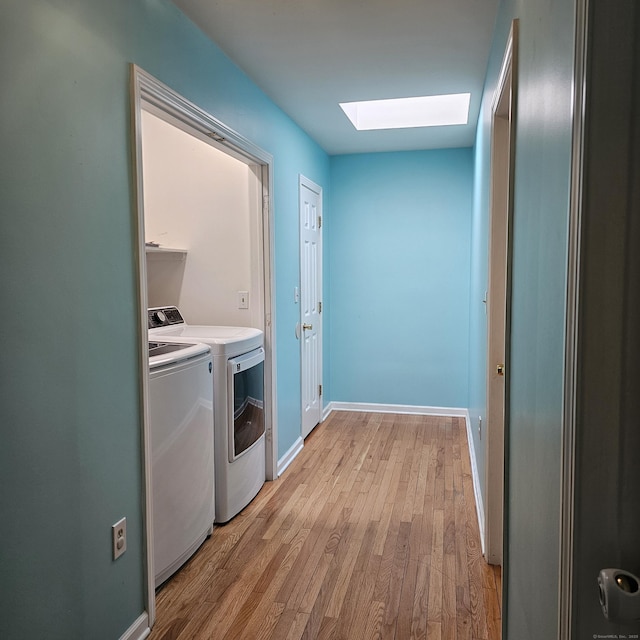 50 Meadow St, Meriden, CT 06451 - laundry room with a skylight, washer and clothes dryer, and light wood-style floors