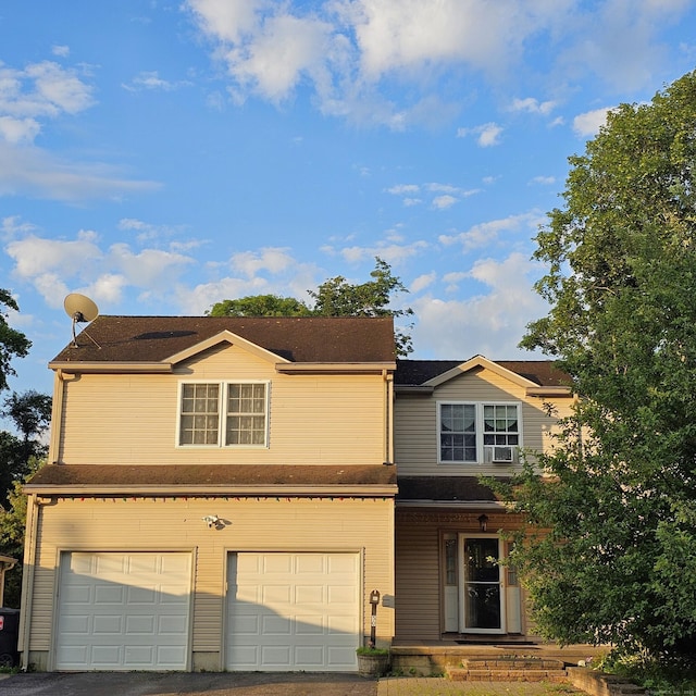 50 Meadow St, Meriden, CT 06451 - view of front facade with an attached garage, cooling unit, and asphalt driveway