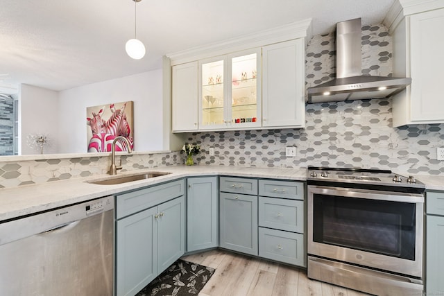 28 Biltmore Park Unit 28, Bloomfield, CT 06002 - kitchen with appliances with stainless steel finishes, wall chimney range hood, light countertops, light wood-style flooring, and tasteful backsplash