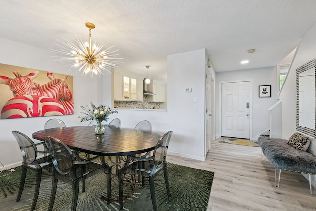 28 Biltmore Park Unit 28, Bloomfield, CT 06002 - dining area featuring a chandelier, light wood-style floors, stairway, and a textured ceiling