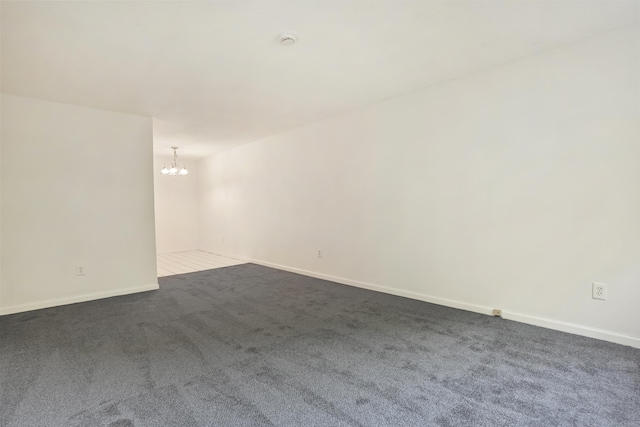 34A Padanaram Ave Unit 120, Danbury, CT 06811 - empty room featuring a chandelier, dark carpet, and a smoke detector