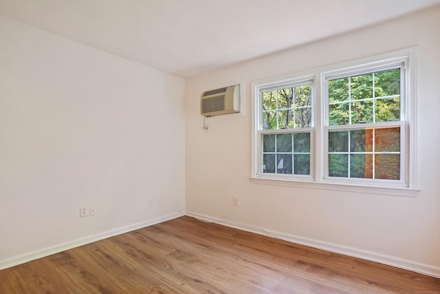 34A Padanaram Ave Unit 120, Danbury, CT 06811 - unfurnished room with a wall mounted AC and light wood-style floors