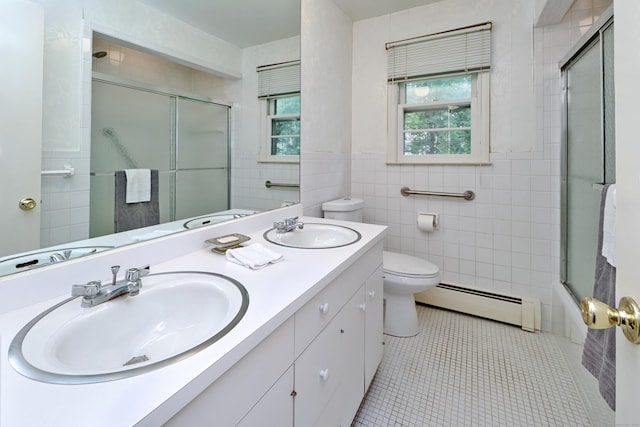 355 Surrey Ln, Fairfield, CT 06824 - full bath featuring a baseboard radiator, tile walls, double vanity, tile patterned floors, and bath / shower combo with glass door