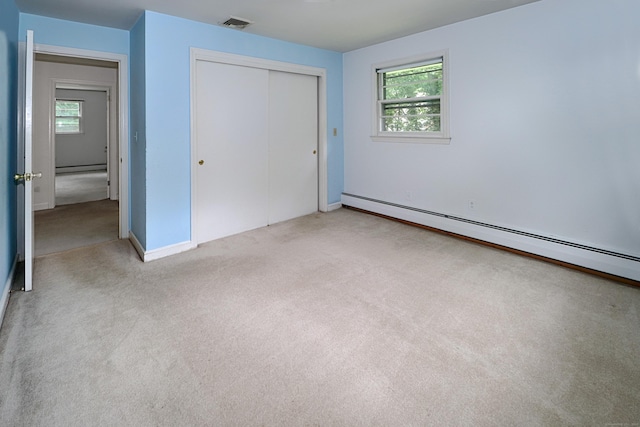 355 Surrey Ln, Fairfield, CT 06824 - unfurnished bedroom featuring light colored carpet, a baseboard heating unit, and a closet