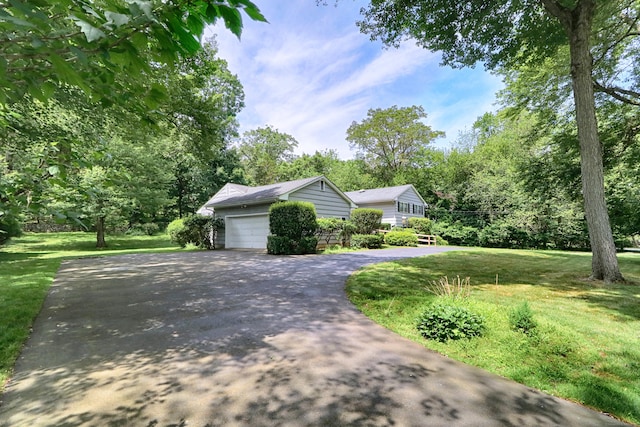 355 Surrey Ln, Fairfield, CT 06824 - view of front of house with asphalt driveway, a front yard, and a garage