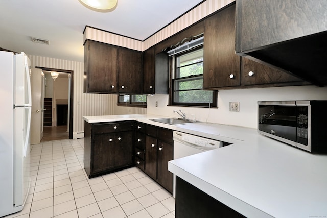 355 Surrey Ln, Fairfield, CT 06824 - kitchen featuring white appliances, light tile patterned floors, light countertops, dark brown cabinets, and wallpapered walls