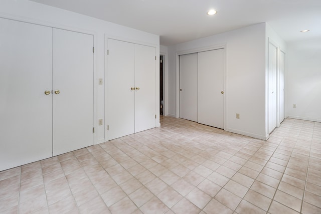 355 Surrey Ln, Fairfield, CT 06824 - unfurnished bedroom featuring multiple closets and recessed lighting