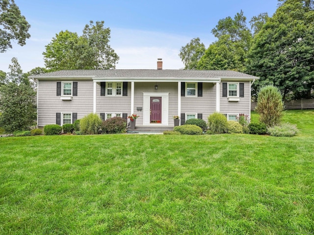 24 Silwen Ln, Norwalk, CT 06851 - bi-level home with a chimney, a front yard, and a shingled roof