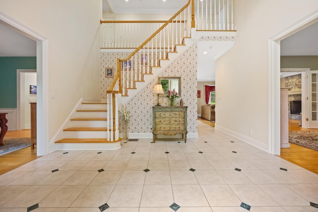 28 Sunnyview Dr, Redding, CT 06896 - staircase with a high ceiling, tile patterned flooring, and crown molding