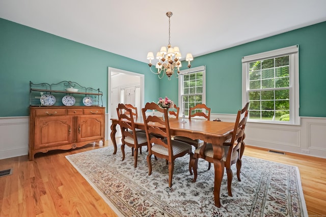 28 Sunnyview Dr, Redding, CT 06896 - dining space featuring a chandelier, a wainscoted wall, and light wood-style floors