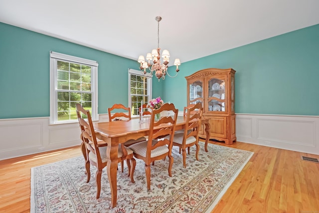 28 Sunnyview Dr, Redding, CT 06896 - dining space with a chandelier, light wood-type flooring, wainscoting, and a decorative wall