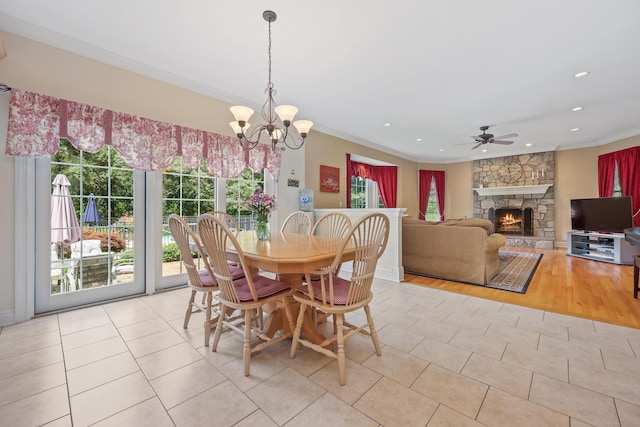 28 Sunnyview Dr, Redding, CT 06896 - dining area with light tile patterned floors, ceiling fan, ornamental molding, a stone fireplace, and a chandelier