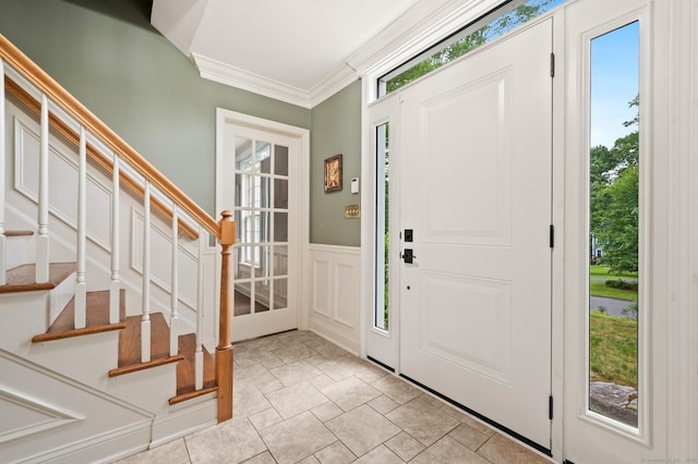 70 Shane Dr, Southbury, CT 06488 - foyer entrance featuring stairs, ornamental molding, stone tile flooring, a decorative wall, and a wainscoted wall