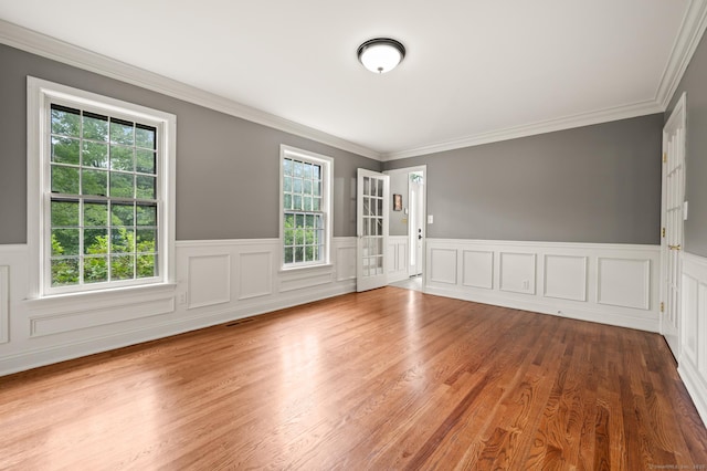 70 Shane Dr, Southbury, CT 06488 - unfurnished room featuring wainscoting, crown molding, wood finished floors, and a decorative wall