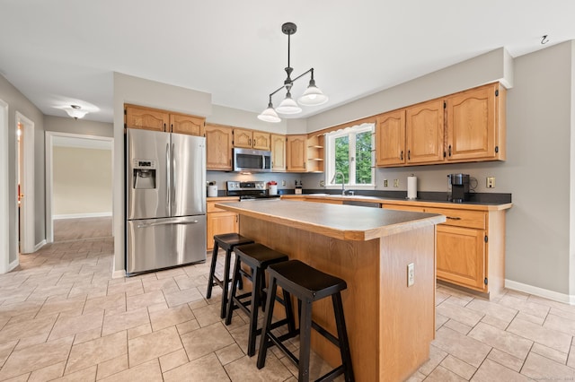 70 Shane Dr, Southbury, CT 06488 - kitchen featuring appliances with stainless steel finishes, open shelves, a center island, decorative light fixtures, and a kitchen bar