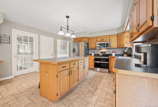70 Shane Dr, Southbury, CT 06488 - kitchen with appliances with stainless steel finishes, a kitchen island, hanging light fixtures, and light stone finish floors