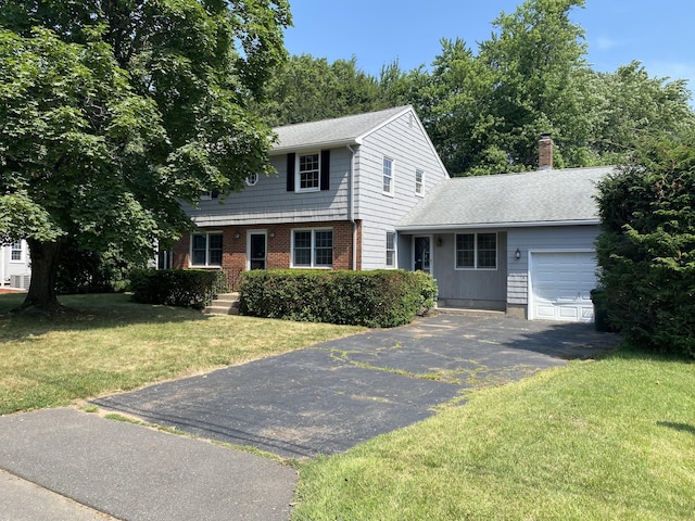 18 Depietro Dr, East Hartford, CT 06118 - colonial inspired home with driveway, a garage, a front yard, a chimney, and a shingled roof