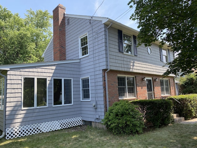 18 Depietro Dr, East Hartford, CT 06118 - view of front of home featuring a chimney and a front lawn