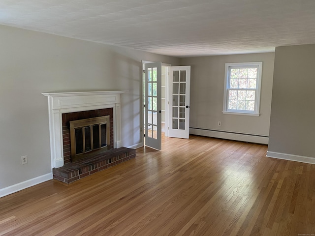 18 Depietro Dr, East Hartford, CT 06118 - unfurnished living room featuring a baseboard heating unit, healthy amount of natural light, wood finished floors, and a fireplace