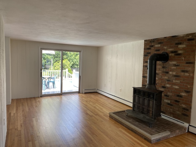 18 Depietro Dr, East Hartford, CT 06118 - unfurnished living room featuring a wood stove, wood finished floors, and baseboard heating