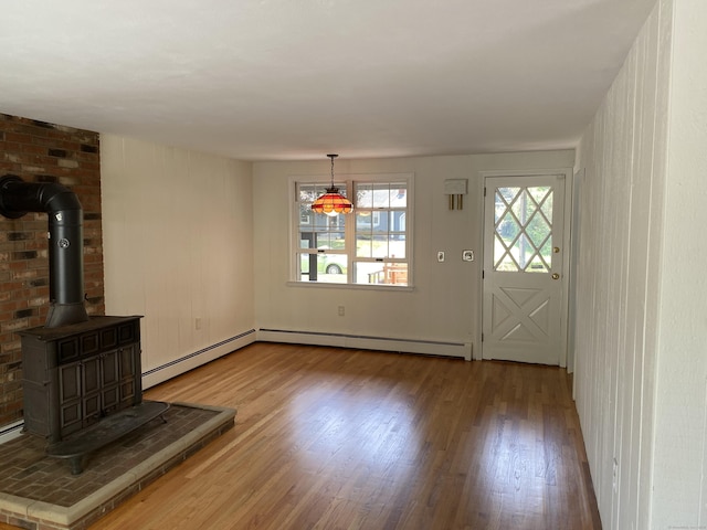 18 Depietro Dr, East Hartford, CT 06118 - unfurnished living room featuring baseboard heating, wood finished floors, and a wood stove