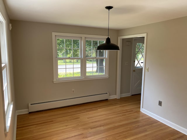 18 Depietro Dr, East Hartford, CT 06118 - unfurnished dining area with baseboard heating, plenty of natural light, and light wood-type flooring