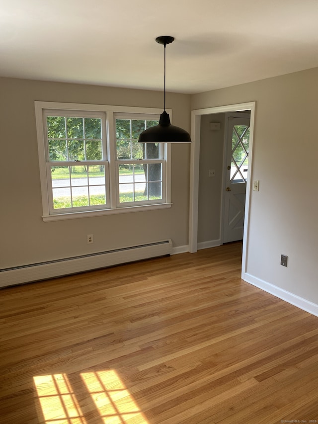 18 Depietro Dr, East Hartford, CT 06118 - unfurnished dining area featuring a baseboard heating unit and light wood-type flooring