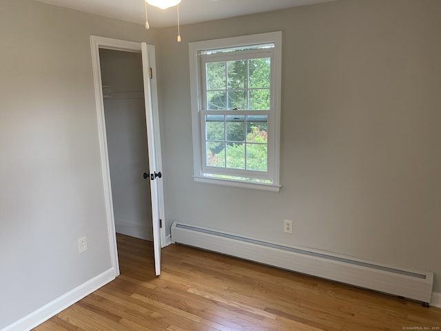18 Depietro Dr, East Hartford, CT 06118 - unfurnished bedroom with a baseboard heating unit, light wood-style flooring, and a closet