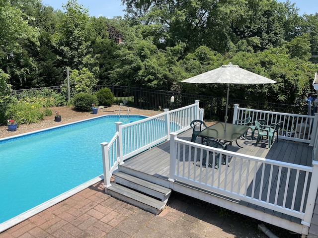 18 Depietro Dr, East Hartford, CT 06118 - view of swimming pool with a fenced backyard, a wooden deck, and outdoor dining area