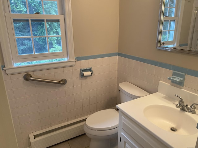 18 Depietro Dr, East Hartford, CT 06118 - half bathroom with a baseboard heating unit, healthy amount of natural light, tile walls, wainscoting, and vanity