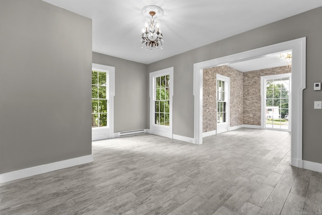 286 Marlborough St, Portland, CT 06480 - unfurnished room with a baseboard heating unit, a chandelier, wood finished floors, and plenty of natural light