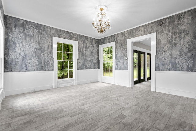 286 Marlborough St, Portland, CT 06480 - spare room featuring healthy amount of natural light, a chandelier, a wainscoted wall, wood finished floors, and wallpapered walls