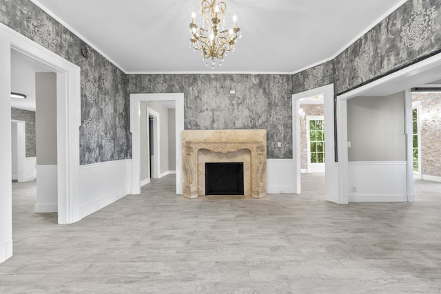 286 Marlborough St, Portland, CT 06480 - unfurnished living room with plenty of natural light, a chandelier, a fireplace, wainscoting, and ornamental molding