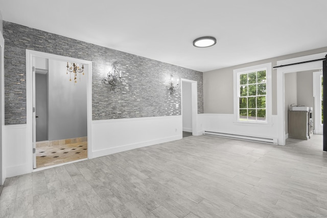 286 Marlborough St, Portland, CT 06480 - spare room with a baseboard radiator, a barn door, wood finished floors, and a chandelier